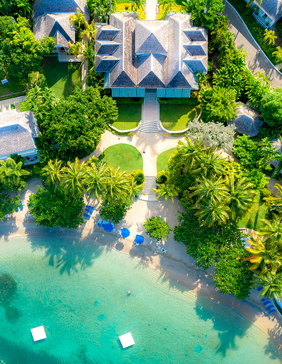 Aerial view of Pineapple House, Round Hill's beach, and turquoise water