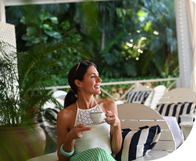 Guest enjoying tea in a striped Round Hill setting